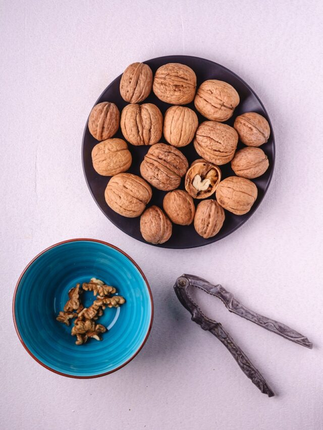 a bowl of nuts next to a bowl of walnuts