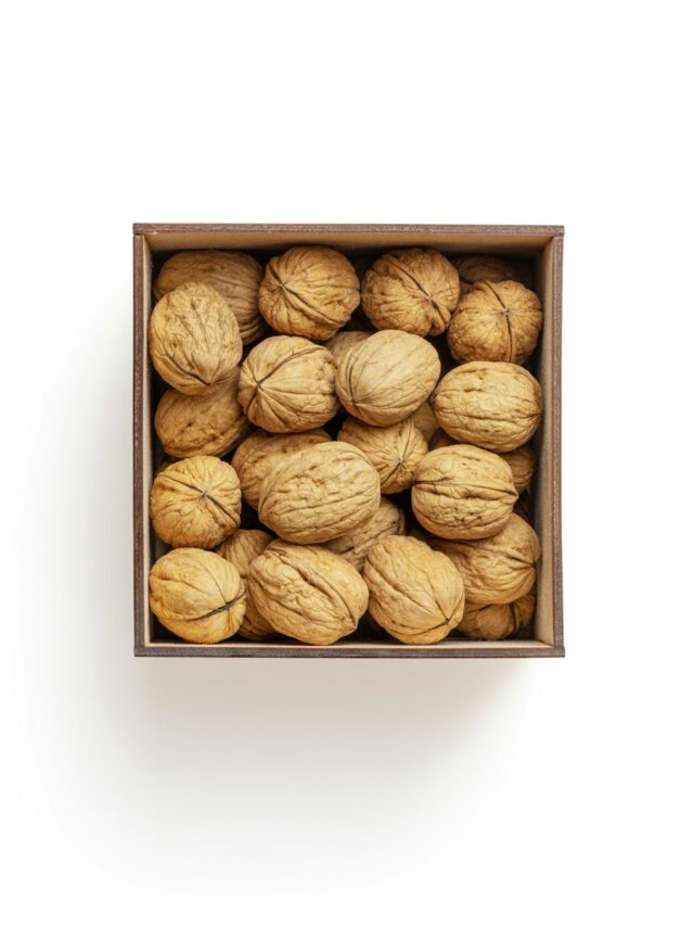 brown almond nuts on white surface