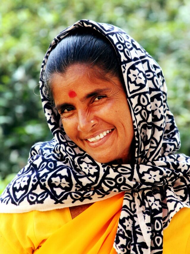 woman wearing white and black floral scarf while smiling