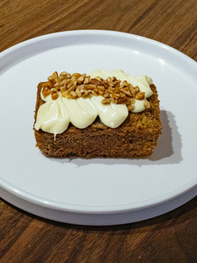 A white plate topped with a piece of cake