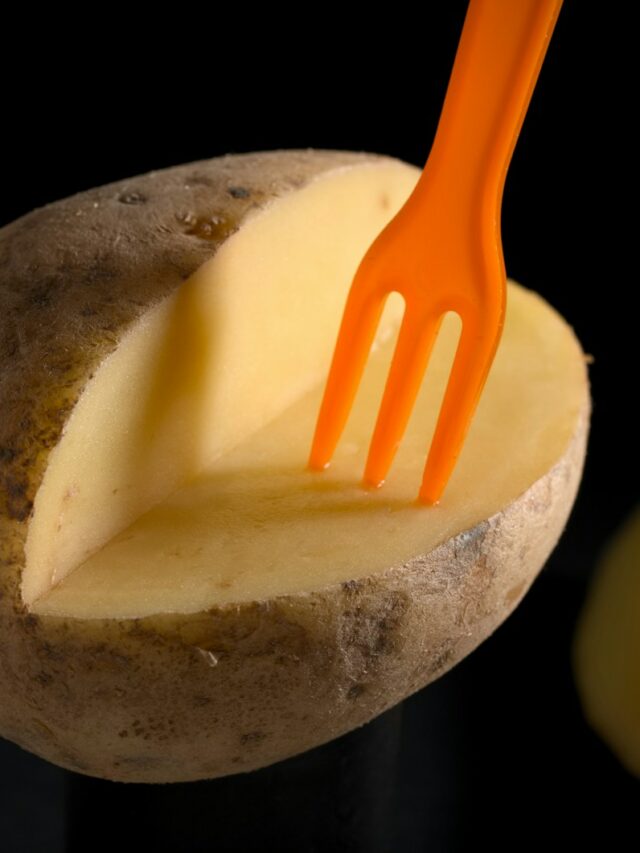 orange plastic fork on brown potato