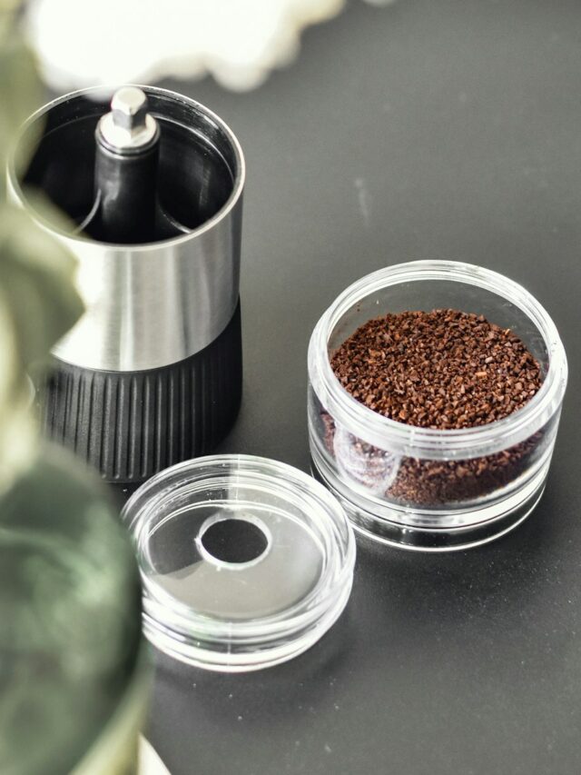 a coffee grinder sitting on top of a black table