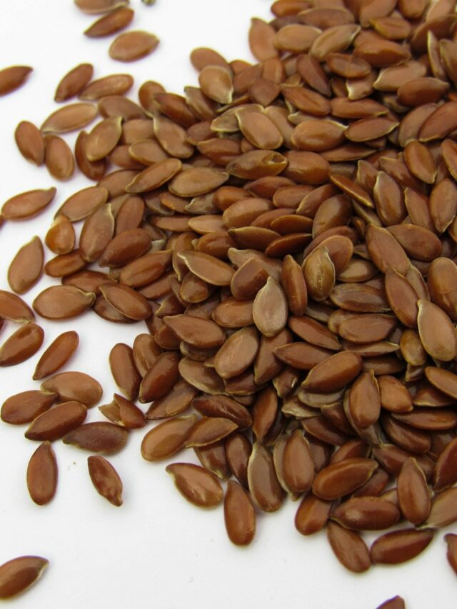 a pile of sunflower seeds on a white surface