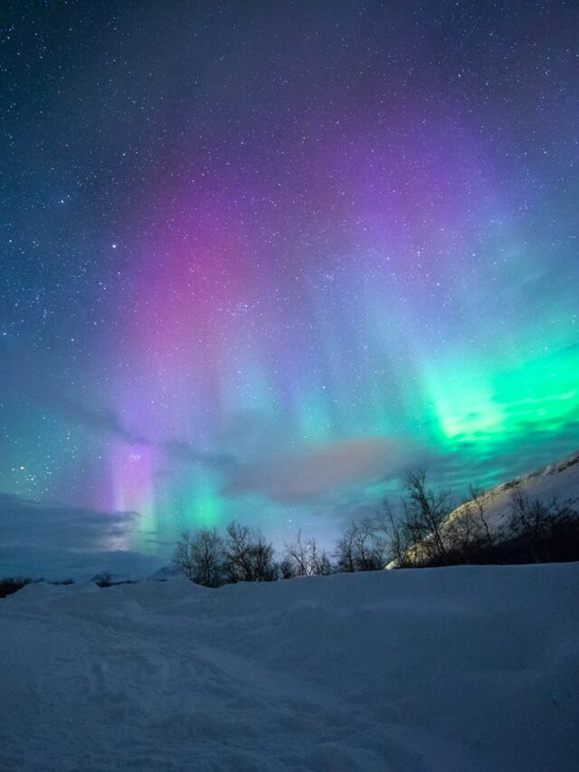 northern lights over snow-capped mountian