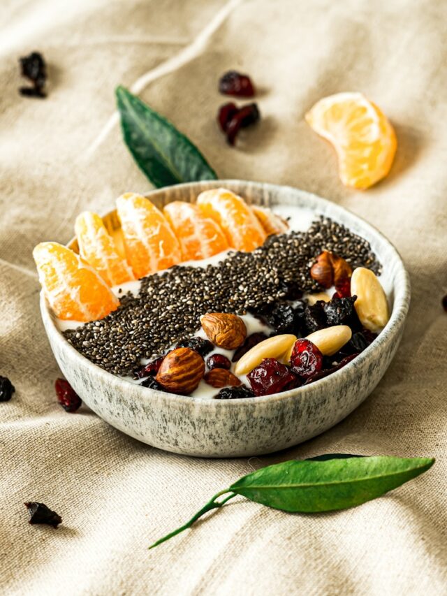 a bowl filled with fruit and nuts on top of a table