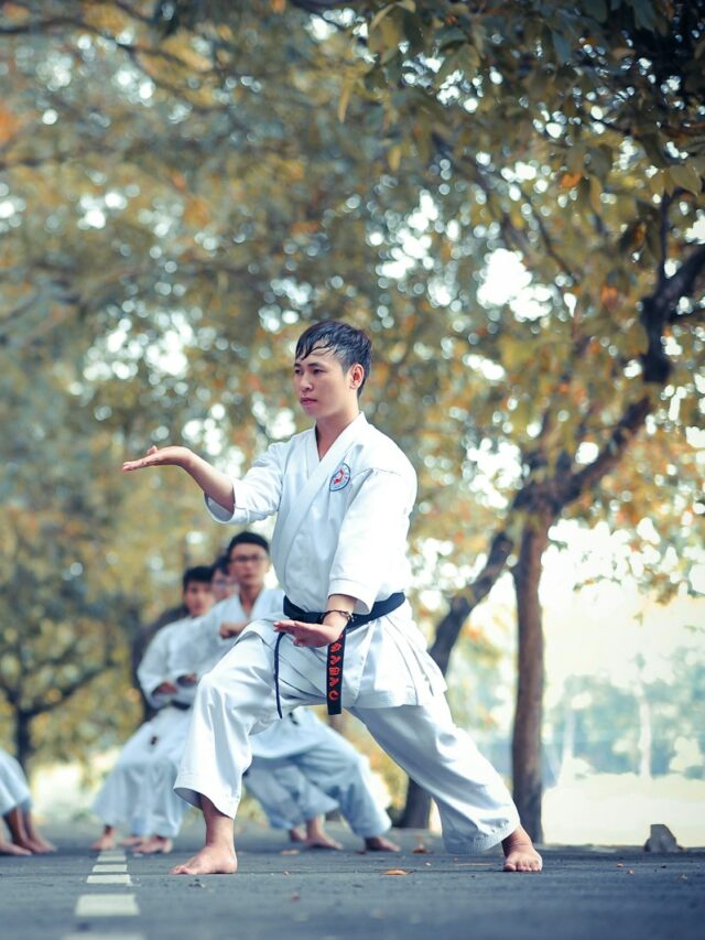 man and woman doing karate on road at daytime