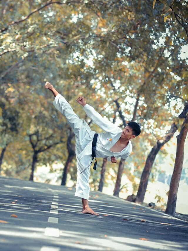 man wearing karate gi standing on road