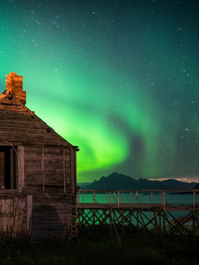 brown wooden house near body of water